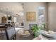 Bright dining area with seating for four opens to the living room with hardwood style floors at 18926 W 93Rd Ave, Arvada, CO 80007