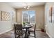 Cozy dining room with a round table and large windows, perfect for intimate meals at 18926 W 93Rd Ave, Arvada, CO 80007