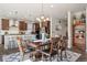 Elegant dining room with stylish chandelier, hardwood floors and views of the modern kitchen at 18926 W 93Rd Ave, Arvada, CO 80007