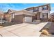 Attractive two-story home featuring a brick and neutral-toned exterior with an attached two-car garage and a well-maintained front lawn at 18926 W 93Rd Ave, Arvada, CO 80007