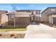 Inviting two-story home with brick accents, well-manicured lawn, and a spacious driveway at 18926 W 93Rd Ave, Arvada, CO 80007