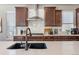 Modern kitchen with quartz countertops, dark cabinetry, stainless steel appliances, and tile backsplash at 18926 W 93Rd Ave, Arvada, CO 80007