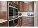 Modern kitchen showcasing stainless steel appliances, dark cabinetry, and ample counter space for food preparation at 18926 W 93Rd Ave, Arvada, CO 80007