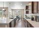 Well-lit kitchen featuring a large island, modern appliances, and an open dining area at 18926 W 93Rd Ave, Arvada, CO 80007