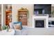 Cozy living room featuring a fireplace, bookshelves, and a comfortable armchair at 18926 W 93Rd Ave, Arvada, CO 80007