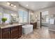 Elegant primary bathroom showcasing a soaking tub, dual sinks, and stylish fixtures for a luxurious spa experience at 18926 W 93Rd Ave, Arvada, CO 80007