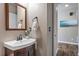 Stylish powder room boasts a modern vanity, decorative mirror, and sleek fixtures at 18926 W 93Rd Ave, Arvada, CO 80007