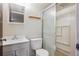Cozy bathroom features a shower with glass door, toilet and sink with mirror at 4591 S Pennsylvania St, Englewood, CO 80113