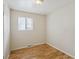 Neutral bedroom featuring hardwood floors and a bright window offering natural light at 4591 S Pennsylvania St, Englewood, CO 80113