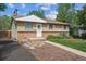 Charming home featuring a well-manicured lawn, brick accents, and a welcoming walkway to the front door at 4591 S Pennsylvania St, Englewood, CO 80113