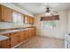 Cozy kitchen featuring wooden cabinets, natural light, and ample counter space at 4591 S Pennsylvania St, Englewood, CO 80113