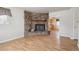 Inviting living room featuring a stone fireplace and gleaming hardwood floors at 4591 S Pennsylvania St, Englewood, CO 80113