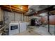 Unfinished basement laundry area with a washer, dryer, utility sink, exposed ductwork, and storage at 12426 W Temple Dr, Morrison, CO 80465