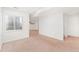 Finished basement featuring neutral carpet, a large window, and white walls at 2430 S Halifax Way, Aurora, CO 80013