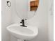 Modern half-bathroom with a pedestal sink and decorative wall accents at 2430 S Halifax Way, Aurora, CO 80013
