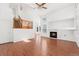 Bright living room featuring hardwood floors, a fireplace, and staircase to the upper level at 2430 S Halifax Way, Aurora, CO 80013