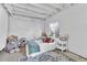 Finished basement with white walls and ceiling, cozy carpet, and small bed with accent pillows at 631 Felicity Loop, Castle Rock, CO 80109