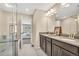 Luxury bathroom with dual sinks, walk-in glass shower and views to bedroom, creating a spa-like experience at 631 Felicity Loop, Castle Rock, CO 80109