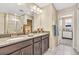 Bathroom featuring double sink vanity, a glass enclosed shower, and neutral color scheme at 631 Felicity Loop, Castle Rock, CO 80109
