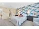 Modern bedroom features a stylish accent wall, neutral carpet, and comfortable furnishings at 631 Felicity Loop, Castle Rock, CO 80109