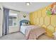 Bright bedroom with fun yellow accent wall, playful decor, and comfortable bed at 631 Felicity Loop, Castle Rock, CO 80109