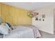 Bedroom featuring a honeycomb accent wall, plush pillows, bright white linens, and cute decorations at 631 Felicity Loop, Castle Rock, CO 80109