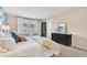 Bright bedroom with large windows offering scenic views and a sleek black dresser with gold accents at 631 Felicity Loop, Castle Rock, CO 80109