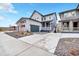 Exterior view of the home with a three car garage, manicured lawn, and modern architectural details at 631 Felicity Loop, Castle Rock, CO 80109