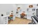 Spacious home office with a large desk, floating shelves, wood floors and natural light at 631 Felicity Loop, Castle Rock, CO 80109