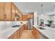 Modern kitchen featuring wood cabinets, stainless steel appliances, quartz countertops, and a stylish backsplash at 631 Felicity Loop, Castle Rock, CO 80109