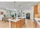 Open kitchen with island, stainless steel appliances, pendant lighting, and seamless flow to the living area at 631 Felicity Loop, Castle Rock, CO 80109