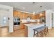 Modern kitchen featuring wooden cabinets, a white countertop island with bar seating, and stainless steel appliances at 631 Felicity Loop, Castle Rock, CO 80109