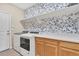 Laundry room featuring floral wallpaper, front loading washer and dryer at 631 Felicity Loop, Castle Rock, CO 80109