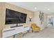 Entertainment space featuring a large screen TV, stylish decor, and a comfortable yellow armchair at 631 Felicity Loop, Castle Rock, CO 80109