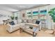 Bright living room with large windows offering scenic views, featuring a comfortable sofa and stylish decor at 631 Felicity Loop, Castle Rock, CO 80109