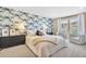 Serene primary bedroom with a feature wall, scenic views from the windows, and comfortable seating at 631 Felicity Loop, Castle Rock, CO 80109