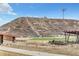 Community recreation area with a sports field, picnic tables, and walking trails leading to a scenic hill at 631 Felicity Loop, Castle Rock, CO 80109