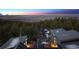 Aerial view of modern home with solar panels, nestled in the woods at 2536 N State Highway 67, Sedalia, CO 80135