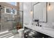 Bathroom featuring a glass-enclosed shower and black vanity with marble countertop at 2536 N State Highway 67, Sedalia, CO 80135