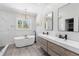 Bright bathroom with soaking tub, double vanity, and modern fixtures at 2536 N State Highway 67, Sedalia, CO 80135