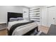 Bedroom with modern decor, striped accent wall and wood floors at 2536 N State Highway 67, Sedalia, CO 80135
