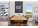 Light-filled dining area with a large table and chairs next to a garage-style glass door at 2536 N State Highway 67, Sedalia, CO 80135