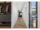 Hallway with wood floors, closet system, and access to outdoor patio at 2536 N State Highway 67, Sedalia, CO 80135
