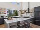 Contemporary kitchen with a large island, sleek appliances, and expansive windows overlooking the lush greenery at 2536 N State Highway 67, Sedalia, CO 80135