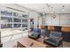 Living room with an indoor/outdoor bar area and a garage-style glass door at 2536 N State Highway 67, Sedalia, CO 80135