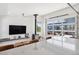 Bright living room featuring a fireplace, TV, and a large window with a view to the outdoor patio at 2536 N State Highway 67, Sedalia, CO 80135
