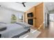 Modern main bedroom with a wood accent wall, fireplace, and beautiful nature views at 2536 N State Highway 67, Sedalia, CO 80135