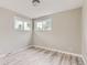 Bright bedroom with two large windows and modern gray wood-look floors at 4624 W Virginia Ave, Denver, CO 80219