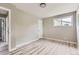 Spacious bedroom with wood-look floors, neutral paint, and a convenient ensuite bath at 4624 W Virginia Ave, Denver, CO 80219