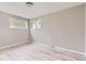 Bright bedroom with wood-look flooring and natural light from two windows at 4624 W Virginia Ave, Denver, CO 80219